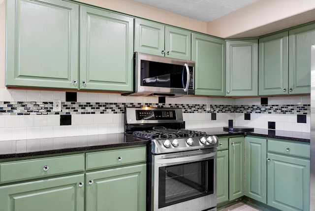 4432 La Paloma Rd NW, Albuquerque, NM 87120 - kitchen featuring stainless steel appliances, green cabinetry, tasteful backsplash, and dark stone countertops
