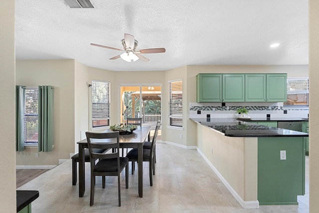 4432 La Paloma Rd NW, Albuquerque, NM 87120 - kitchen featuring green cabinetry, a ceiling fan, dark countertops, backsplash, and a textured ceiling