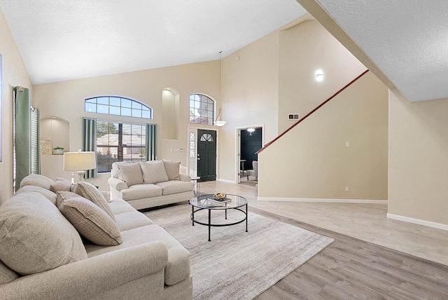 4432 La Paloma Rd NW, Albuquerque, NM 87120 - living room with light wood-type flooring and high vaulted ceiling