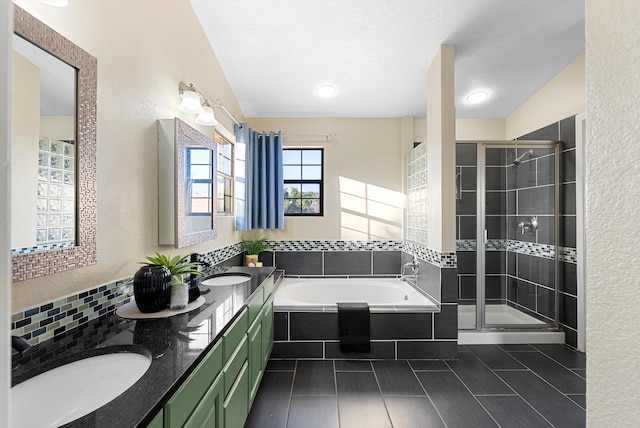 4432 La Paloma Rd NW, Albuquerque, NM 87120 - bathroom featuring a garden tub, a stall shower, double vanity, a textured wall, and a textured ceiling