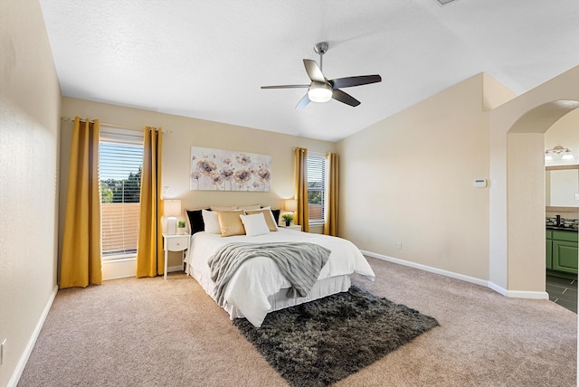 4432 La Paloma Rd NW, Albuquerque, NM 87120 - carpeted bedroom featuring arched walkways, vaulted ceiling, ceiling fan, and connected bathroom