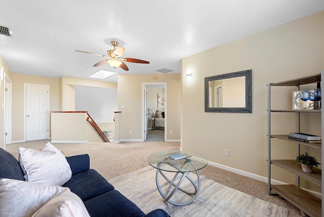 4432 La Paloma Rd NW, Albuquerque, NM 87120 - living room featuring a ceiling fan, light carpet, and a skylight