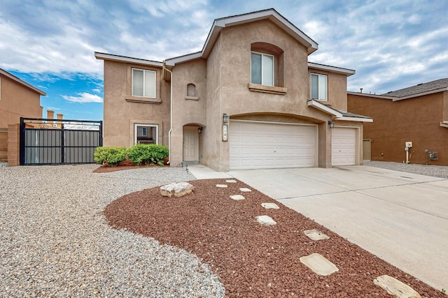 1191 Carrizo St NW, Los Lunas, NM 87031 - view of front facade featuring stucco siding, a garage, and concrete driveway