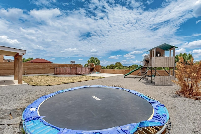 1191 Carrizo St NW, Los Lunas, NM 87031 - view of yard with a trampoline and a playground