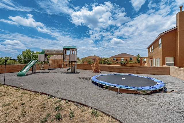 1191 Carrizo St NW, Los Lunas, NM 87031 - communal playground featuring a trampoline and a fenced backyard
