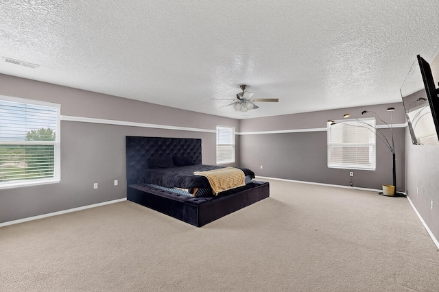 1191 Carrizo St NW, Los Lunas, NM 87031 - bedroom featuring carpet floors, a textured ceiling, and ceiling fan