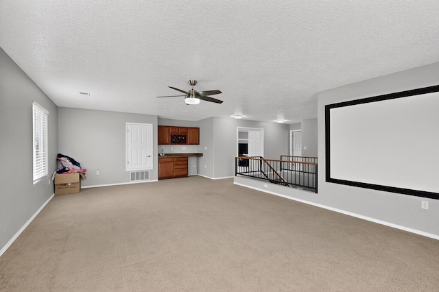 1191 Carrizo St NW, Los Lunas, NM 87031 - cinema featuring light carpet, ceiling fan, and a textured ceiling