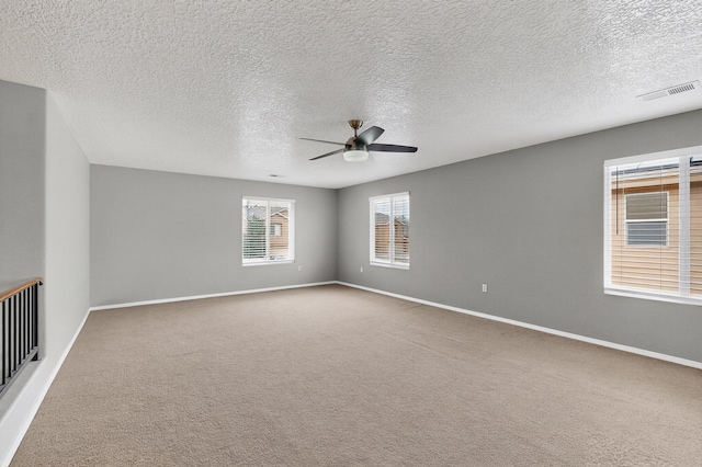 1191 Carrizo St NW, Los Lunas, NM 87031 - carpeted empty room featuring a ceiling fan and a textured ceiling