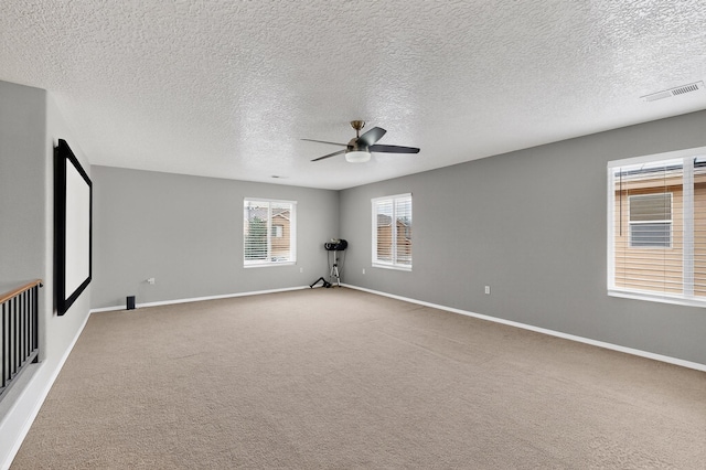 1191 Carrizo St NW, Los Lunas, NM 87031 - empty room with a ceiling fan, carpet, and a textured ceiling