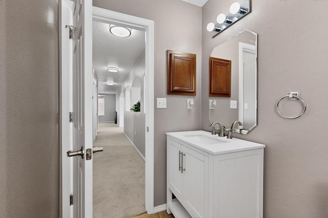 1191 Carrizo St NW, Los Lunas, NM 87031 - bathroom with vanity and a textured ceiling