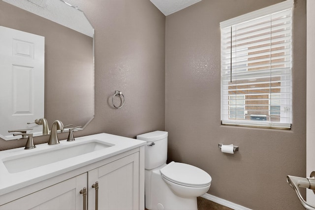 1191 Carrizo St NW, Los Lunas, NM 87031 - half bathroom featuring vanity and a textured wall