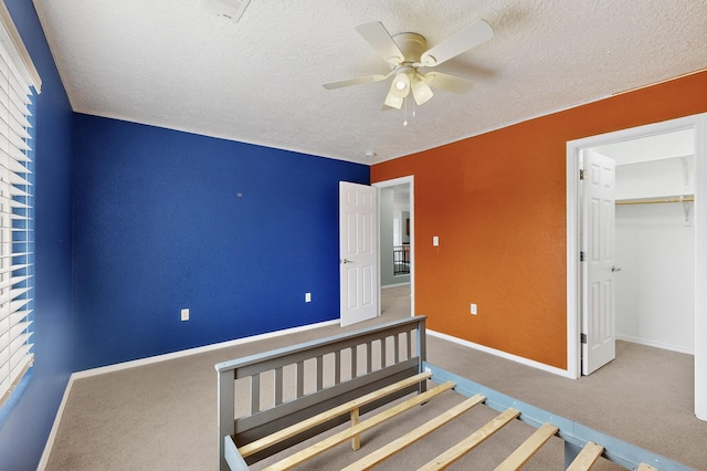 1191 Carrizo St NW, Los Lunas, NM 87031 - unfurnished bedroom with carpet flooring, a textured ceiling, and ceiling fan