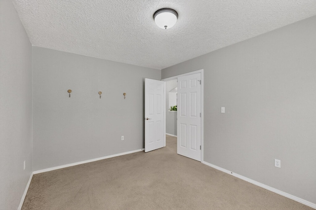 1191 Carrizo St NW, Los Lunas, NM 87031 - unfurnished room with light colored carpet and a textured ceiling