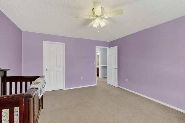 1191 Carrizo St NW, Los Lunas, NM 87031 - carpeted bedroom featuring a textured ceiling and a ceiling fan