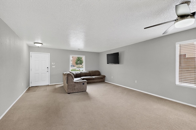 1191 Carrizo St NW, Los Lunas, NM 87031 - carpeted living area with a textured ceiling and a ceiling fan