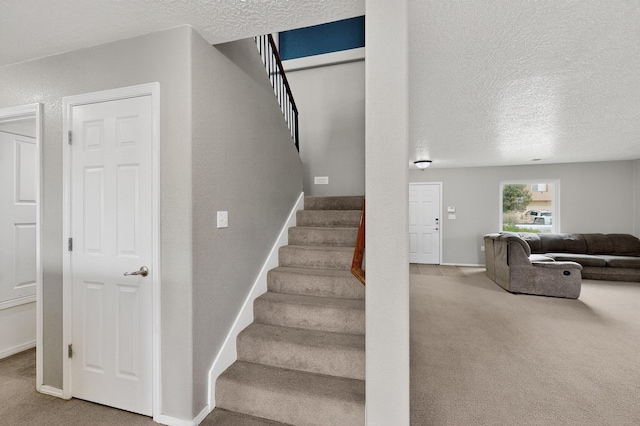 1191 Carrizo St NW, Los Lunas, NM 87031 - stairs featuring carpet flooring and a textured ceiling