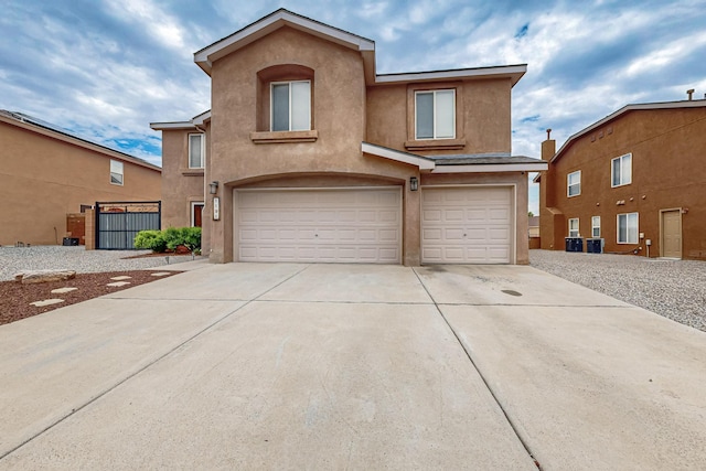 1191 Carrizo St NW, Los Lunas, NM 87031 - view of front of home featuring an attached garage, stucco siding, and concrete driveway