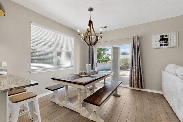 3546 Newcastle Dr SE, Rio Rancho, NM 87124 - dining area with a chandelier and light wood finished floors