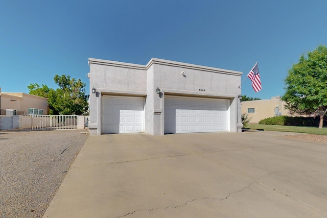 3546 Newcastle Dr SE, Rio Rancho, NM 87124 - view of front of home featuring stucco siding, driveway, and an attached garage