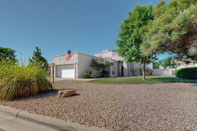 3546 Newcastle Dr SE, Rio Rancho, NM 87124 - view of front of home featuring a garage, stucco siding, and concrete driveway