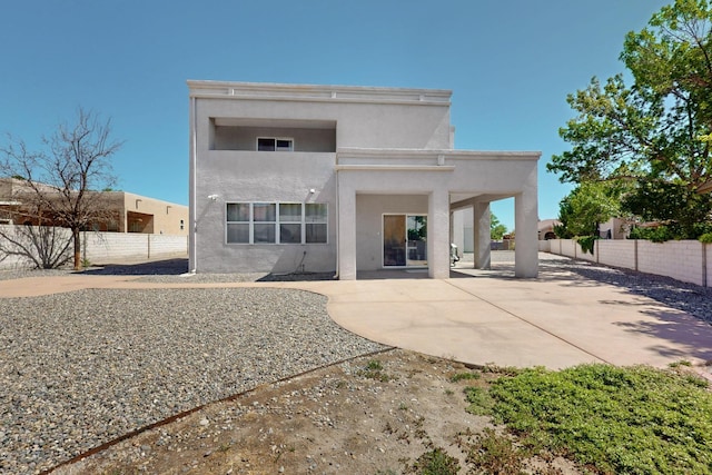 3546 Newcastle Dr SE, Rio Rancho, NM 87124 - back of house with stucco siding, a patio area, and a fenced backyard