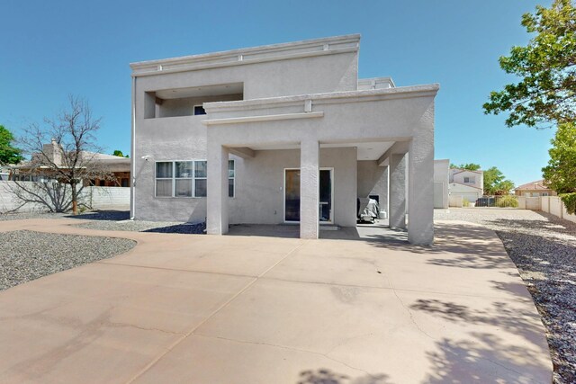 3546 Newcastle Dr SE, Rio Rancho, NM 87124 - rear view of house featuring stucco siding and a patio area