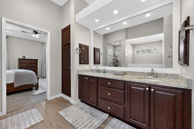 3546 Newcastle Dr SE, Rio Rancho, NM 87124 - bathroom with wood finished floors, double vanity, a stall shower, and recessed lighting