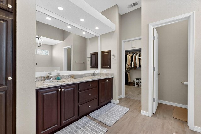 3546 Newcastle Dr SE, Rio Rancho, NM 87124 - full bath with wood finished floors, double vanity, recessed lighting, and a walk in closet