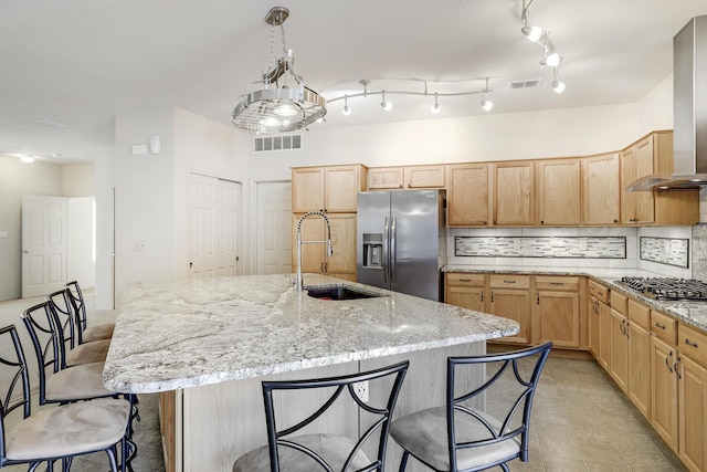 1852 Smarty Jones St SE, Albuquerque, NM 87123 - kitchen with appliances with stainless steel finishes, wall chimney exhaust hood, and light brown cabinets