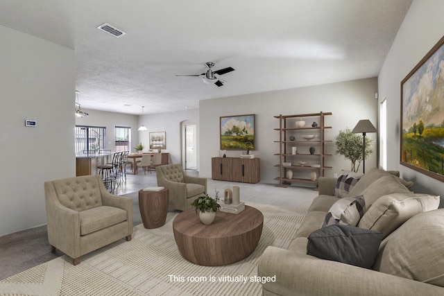 1852 Smarty Jones St SE, Albuquerque, NM 87123 - living area with carpet, a ceiling fan, and a textured ceiling
