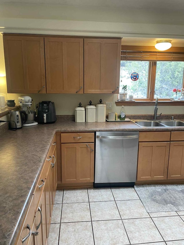 34358 US Highway 285, Ojo Caliente, NM 87549 - kitchen with dishwasher, light tile patterned flooring, dark countertops, and brown cabinetry