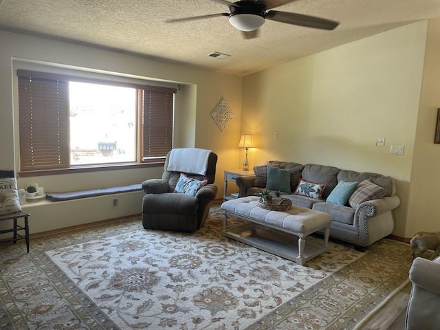 34358 US Highway 285, Ojo Caliente, NM 87549 - living area featuring ceiling fan and a textured ceiling