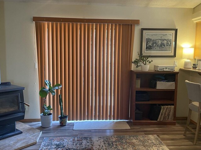34358 US Highway 285, Ojo Caliente, NM 87549 - detailed view of a wood stove, wood finished floors, and radiator