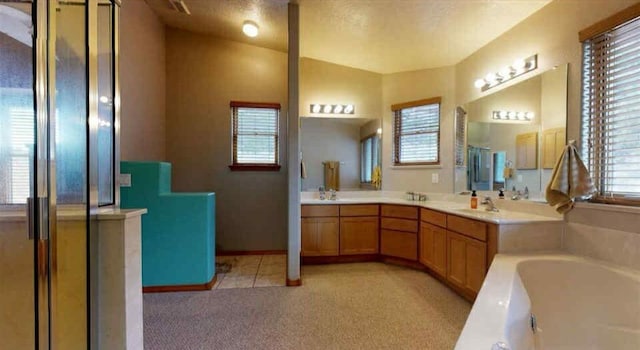 34358 US Highway 285, Ojo Caliente, NM 87549 - bathroom with a garden tub, double vanity, and a shower with shower door