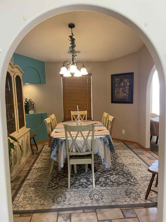 34358 US Highway 285, Ojo Caliente, NM 87549 - dining space featuring arched walkways and a chandelier