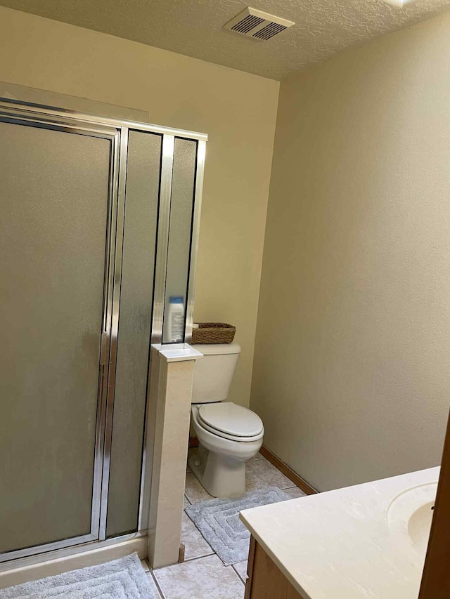 34358 US Highway 285, Ojo Caliente, NM 87549 - full bathroom with vanity, a shower stall, a textured ceiling, and tile patterned flooring