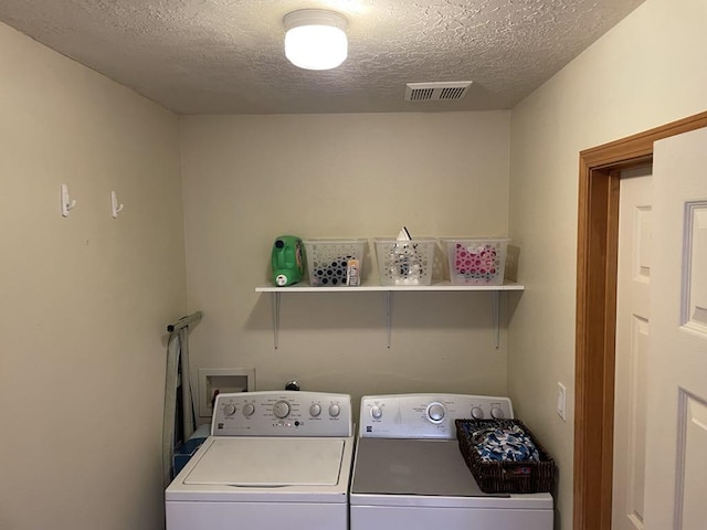 34358 US Highway 285, Ojo Caliente, NM 87549 - washroom with washer and clothes dryer and a textured ceiling