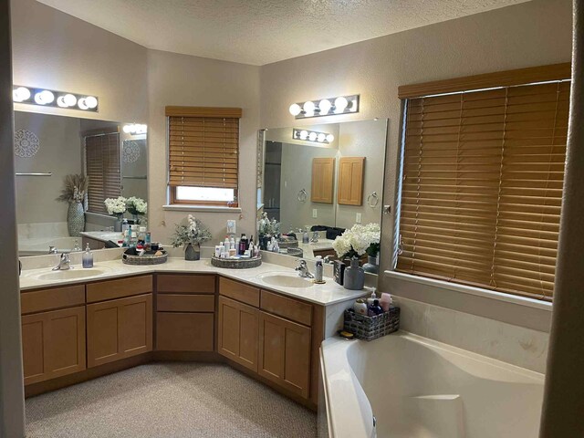 34358 US Highway 285, Ojo Caliente, NM 87549 - bathroom with a garden tub, double vanity, and a textured ceiling