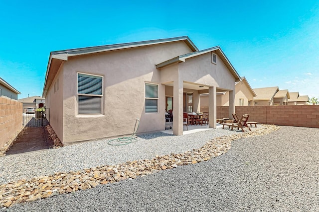 4276 Crowned Eagle Loop NE, Rio Rancho, NM 87144 - back of property with stucco siding, a fenced backyard, and a patio