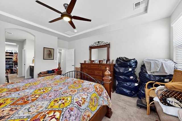 4276 Crowned Eagle Loop NE, Rio Rancho, NM 87144 - bedroom featuring light carpet, arched walkways, a ceiling fan, and a tray ceiling