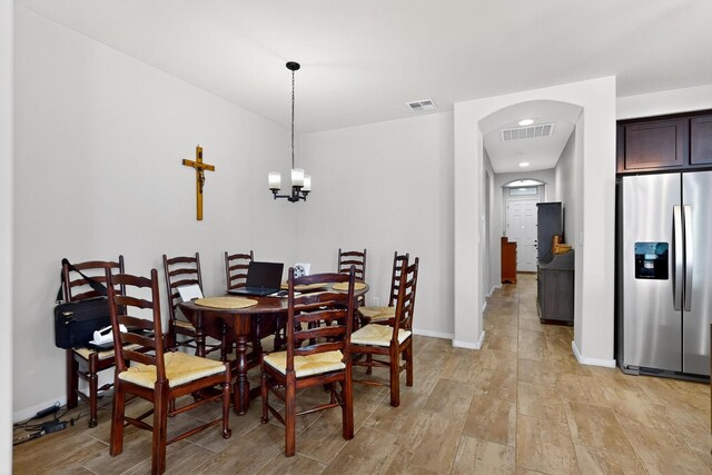 4276 Crowned Eagle Loop NE, Rio Rancho, NM 87144 - dining space with arched walkways, light wood-type flooring, and a chandelier