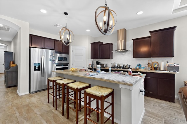 4276 Crowned Eagle Loop NE, Rio Rancho, NM 87144 - kitchen with stainless steel appliances, wall chimney exhaust hood, light countertops, a chandelier, and a breakfast bar