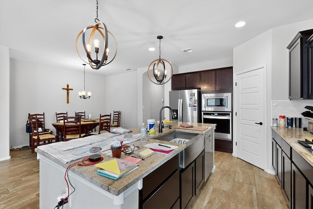 4276 Crowned Eagle Loop NE, Rio Rancho, NM 87144 - kitchen featuring appliances with stainless steel finishes, a chandelier, recessed lighting, a center island with sink, and pendant lighting