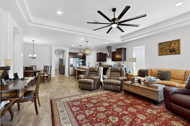 4276 Crowned Eagle Loop NE, Rio Rancho, NM 87144 - living area with a chandelier, a tray ceiling, a ceiling fan, arched walkways, and recessed lighting