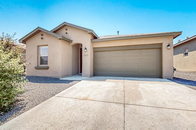 4276 Crowned Eagle Loop NE, Rio Rancho, NM 87144 - view of front of property featuring stucco siding, driveway, and a garage