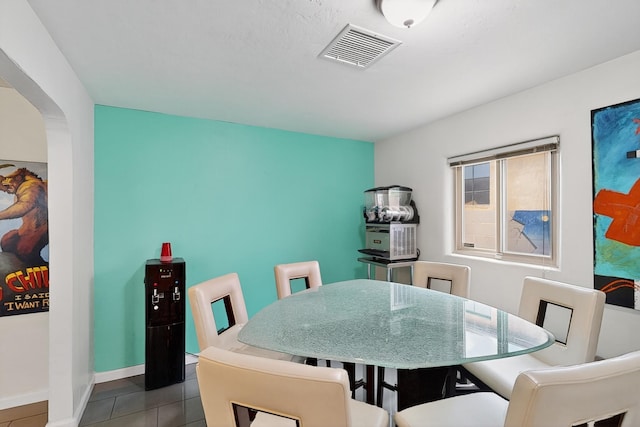 1308 Boatright Dr NE, Albuquerque, NM 87112 - tiled dining space with arched walkways and baseboards