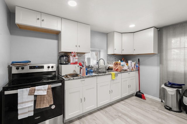 2024 Hinkle St SE, Albuquerque, NM 87102 - kitchen with stainless steel range with electric cooktop, white cabinets, white microwave, stone counters, and light wood-type flooring