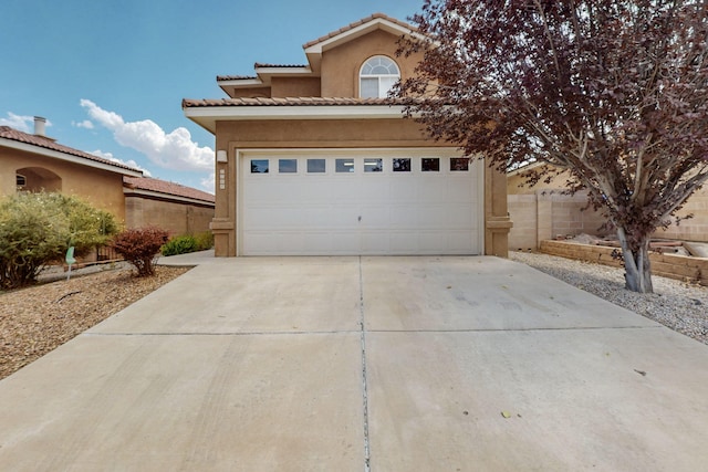 5508 Carefree Ave NW, Albuquerque, NM 87120 - view of front of home featuring concrete driveway, stucco siding, and an attached garage