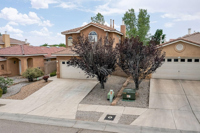 5508 Carefree Ave NW, Albuquerque, NM 87120 - mediterranean / spanish-style home with concrete driveway, stucco siding, and a tiled roof