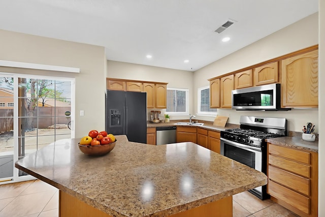 5508 Carefree Ave NW, Albuquerque, NM 87120 - kitchen featuring stainless steel appliances, light tile patterned floors, plenty of natural light, light brown cabinetry, and recessed lighting